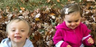 Teaching Toddlers Gratitude title image - toddlers smiling in a pile of leaves