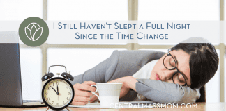 I still haven't slept since the time change title and woman falling asleep at a desk next to an alarm clock