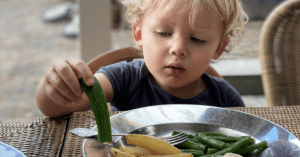 toddler inspecting vegetables