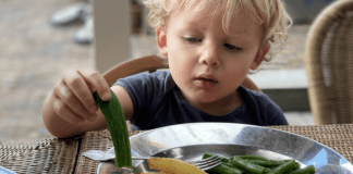 toddler inspecting vegetables