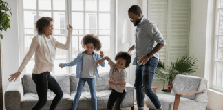 parents and kids finding joy while dancing in their living room