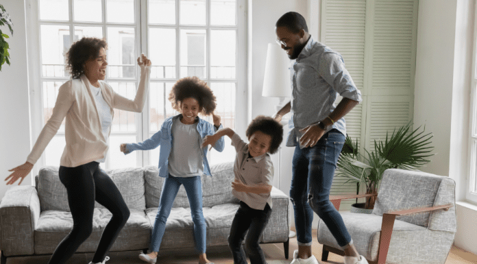 parents and kids finding joy while dancing in their living room