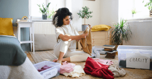 woman sorting through old clothes trying to embody minimalism
