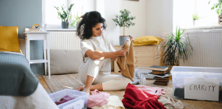 woman sorting through old clothes trying to embody minimalism
