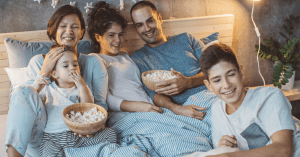 Family tradition - family gathered eating popcorn, watching a movie