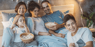 Family tradition - family gathered eating popcorn, watching a movie