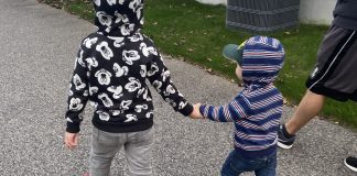 boys walking holding hands, raising boys to be men