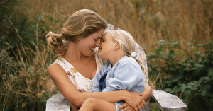 mother cuddling with daughter
