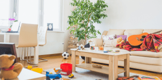 a messy living room with toys and items all over the place