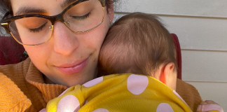 mom snuggling her baby after breastfeeding