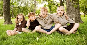 siblings sitting in a park