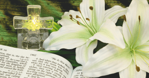 a cross, easter lilies and a bible, to teach kids about easter