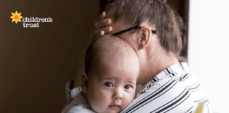 Mom holding an infant managing parenting stress