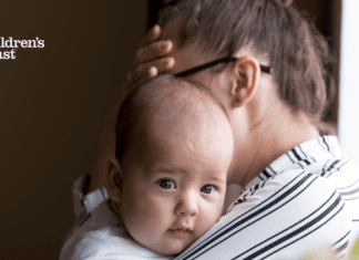 Mom holding an infant managing parenting stress