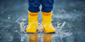 toddler jumping in a puddle, making memories in the little moments