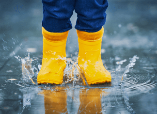 toddler jumping in a puddle, making memories in the little moments