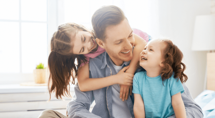 fathers days gift ideas, a father and two daughters laughing and smiling