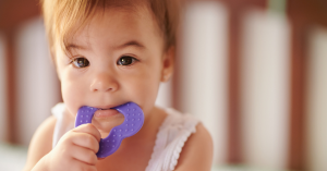 toddler biting on a teething ring