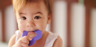 toddler biting on a teething ring