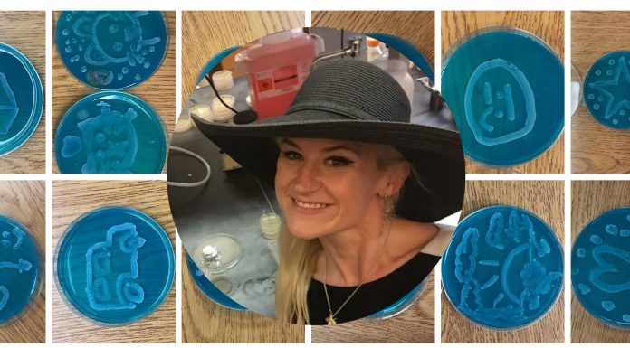 Dr. Anne A. Madden wearing a black wide-brimmed hat in a laboratory. Overlayed on teal Petri dishes with various drawn images on them in baker's yeast.
