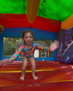 girl jumping inside an inflatable rental bounce house