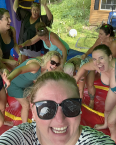 group of moms laughing inside an inflatable rental bounce house