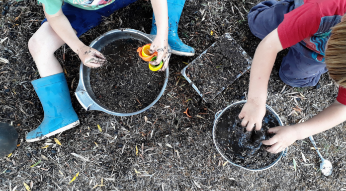 7 Fun and Inexpensive At-Home Spring Break Activities for Kids 2 kids playing in the dirt with buckets for an inexpensive at-home spring break activity