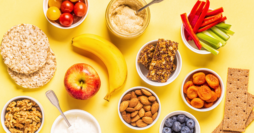 spread of healthy snacks like fruits, vegetables and crackers.